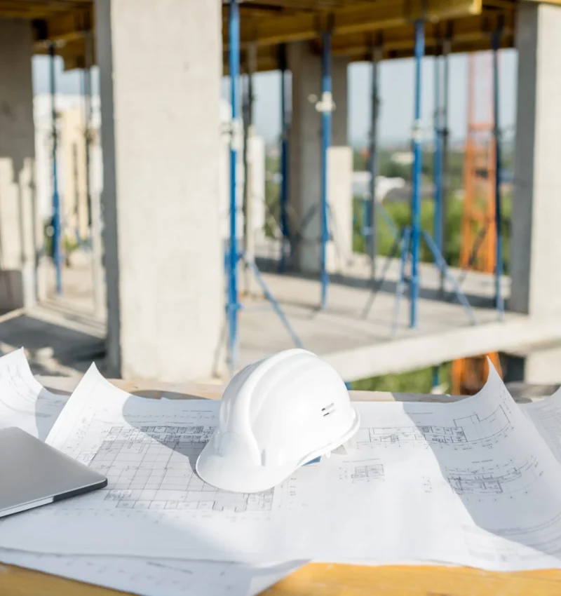 blueprint-and-hard-hat-on-construction-site-table-2026-01-08-23-47-48-utc (1)