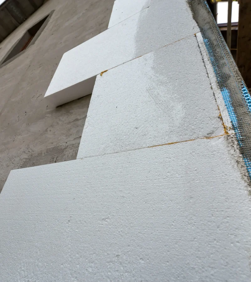 close-up-detail-of-plastered-house-wall-with-rigid-2026-03-09-00-14-59-utc (1)