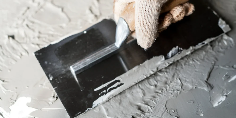 grey-paste-application-with-a-trowel-and-gloved-ha-2026-03-18-10-37-26-utc (1)